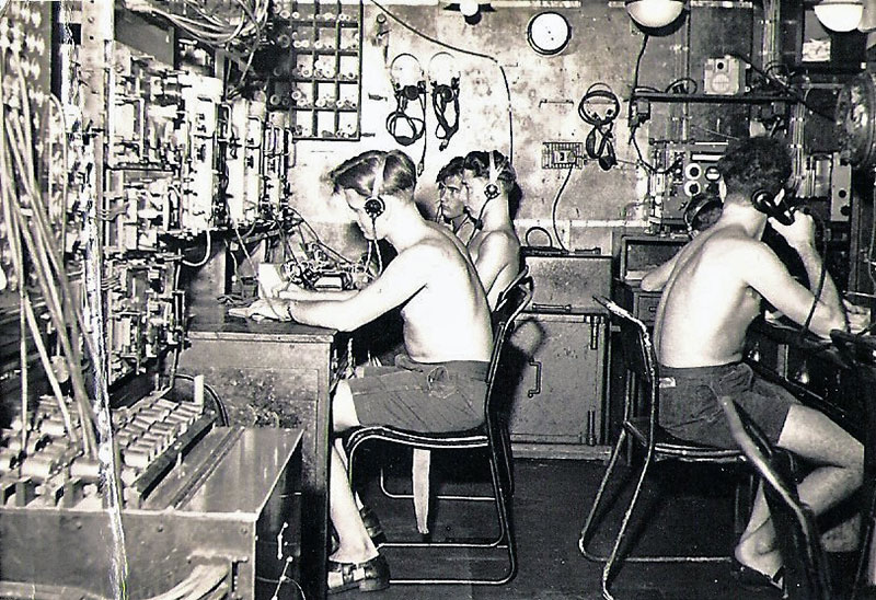HMS Gambia's radio room. Harold Geoff Beestin is the second left.