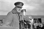 Rear Admiral S. S. Bonham Carter, CB, CVO, DSO, Commanding 18th Cruiser Squadron, whose flagship HMS Edinburgh had the job of welcoming the American Task Force Mid-Atlantic, seen on the bridge of HMS Edinburgh. April 3-4, 1942. Photo: Lt. R. G. G. Coote. Imperial War Museum A 9241