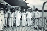 Vice Admiral Norris is piped aboard his new Flag Ship at Trincomalee. Keith Butler is back row, second inboard in 1955/56. Image from Keith Butler