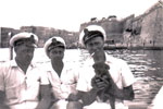 Going ashore at Valletta, the capital city of Malta. Ordnance Artificer Jack Sturges, Electrical Artificers Algy Longworth and Alan Clements with a little friend. Photo from Alan Clements