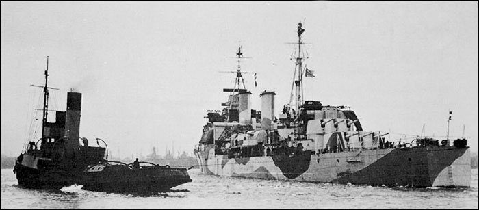 HMS Gambia being towed out - February 1942