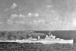 HMS Gambia and HMS Kenya travelling at speed during exercises in the Indian Ocean. April 1952. Ships of four navies, UK, Ceylon, India, and Pakistan combined for exercises designed to strengthen commonwealth protection measures. Imperial War Museum A 32105