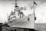 HMS Gambia moored during the 1950-52 commission. Photographer and place unknown