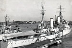 HMS Gambia moored in the Suez Canel during the 1950-52 commission. Photographer unknown