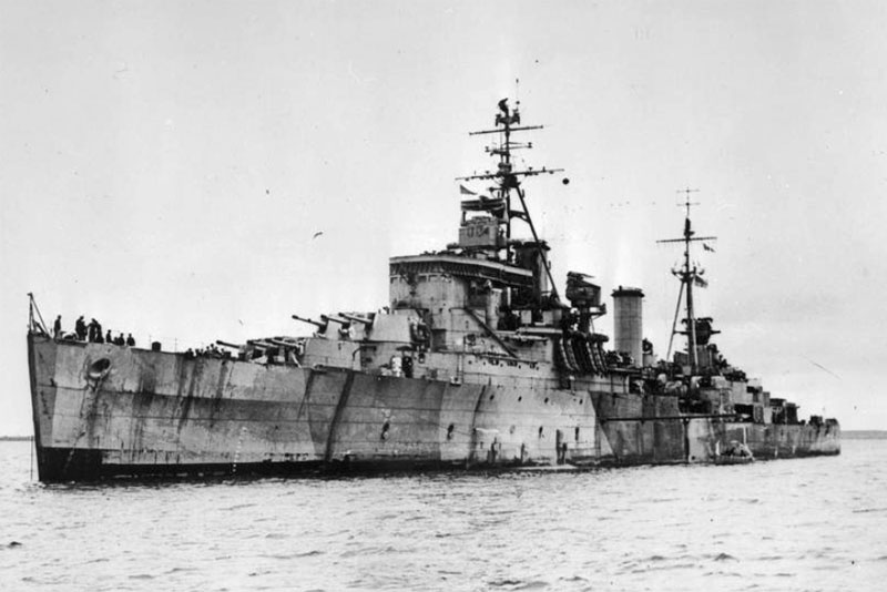 HMS Gambia being towed out - February 1942
