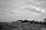 The cruiser HMS Cumberland making smoke during the attack on Sabang. Operation Crimson, July 25, 1944. Photo: Lt. W. E. Rolfe. Imperial War Museums A 25653