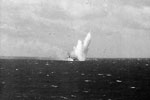 A Japanese kamikaze plane crashing into the sea very close to another British carrier after failing to hit the flight deck. The enemy aircraft was crippled by the HMS illustrious's anti aircraft defences. The Sakishima Islands in May 1945. Imperial War Museums A 29195