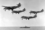 Sea Hawk fighter aircraft of 810 Squadron from HMS Bulwark flying past HMS Cheviot. Singapore, June 9, 1948. Imperial War Museum A A34043