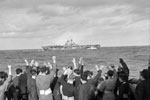 Sailors of HMS Edinburgh greet one of the American ships, USS Wasp in the mid-Atlantic. The task force was under the command of Rear Admiral R. G. Griffen. April 3-4, 1942. Photo: Lt. R. G. G. Coote. Imperial War Museum A 9231