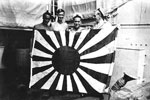 HMNZS Gambia's crew with captured Japanese flag. Photo kindly supplied by Peter Bennett.