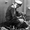 Preparing electrical circuits for Review firework display is Electrical Artificer 5th class J E Owen, of Portsmouth on HMS Superb. Imperial War Museums A32578