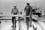 Shipwright Frank Knight of Ewell, Surrey, and OD Alex Wood of Edinburgh, building a platform on HMS Sheffield on June 11, 1953, to enable visiting Sea Cadets to see the Queen on Review Day. Imperial War Museums A32580